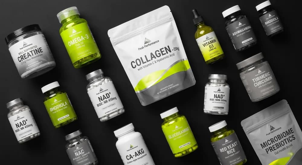 Flat-lay of the Blueprint stack — creatine, omega-3, collagen, NMN/NR, Ca-AKG, curcumin, microbiome prebiotics on a dark background