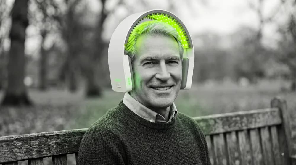 A man wearing a red-light laser cap (LLLT) — evidence-based treatments for hereditary hair loss